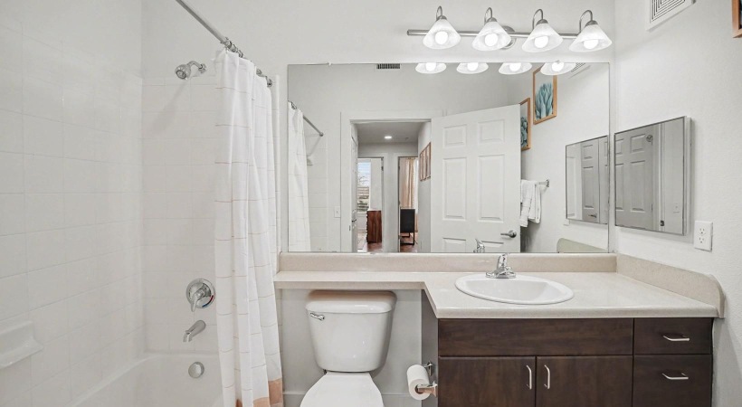 a bathroom with a tub sink and toilet