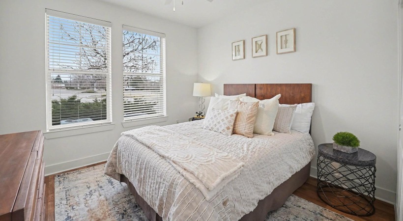 a bedroom with a bed and a fan