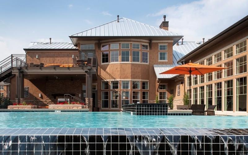 a large building with a pool in front of it
